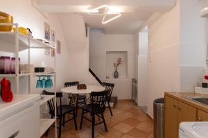 a kitchen with a table and chairs in a room at Green House - Central Stay in Plomari in Plomari