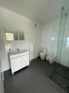 a bathroom with a sink and a toilet at SUN Studio - Apartamentos Vista do Atlântico in Capelo +18 photos