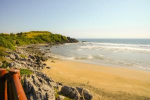 a view of a beach with rocks and the ocean at Refugio de piedra - Troncones in Troncones