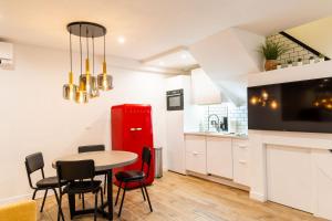 a kitchen with a table and chairs and a red refrigerator at Town House Nation, Bastille, AC by LCC Agency in Paris