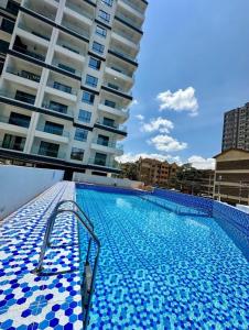 a swimming pool in front of a building at Luxury modern Apartment in Nairobi