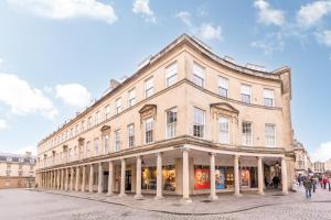 a large building on a street with people walking in front at Bath Street Penthouse in Bath
