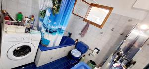a small bathroom with a washing machine in it at SUN and Sea HOUSE Kavala ammolofoi αμμόλοφοι in Eleftheres +41 photos