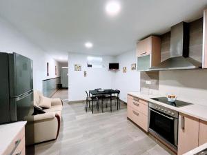 a kitchen with a couch and a table in it at Casa Mary independiente céntrica con terraza cubierta in Porriño