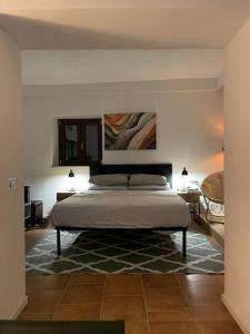 a bedroom with a bed and two tables and two lamps at Stalla suite con living esterno vista mozzafiato in Norma
