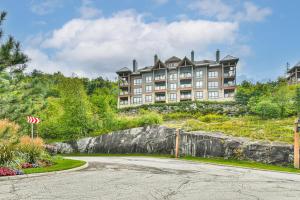 a large building on the side of a hill at Tremblant Prestige - Equinoxe 170-7 in Mont-Tremblant