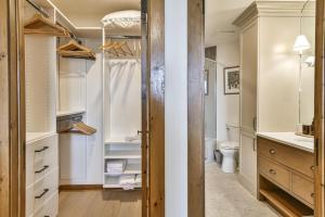 a walk in closet with a toilet and a sink at Tremblant Prestige - Equinoxe 170-7 in Mont-Tremblant +20 photos
