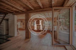 a round mirror in a room with a wooden ceiling at Hunters Lodge Chalet Superior in Alpbach