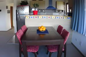 a kitchen with a table with a bowl of oranges on it at Casa Lego in Dina Huapi