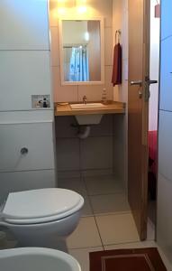 a bathroom with a toilet and a sink at Casa Lego in Dina Huapi +66 photos