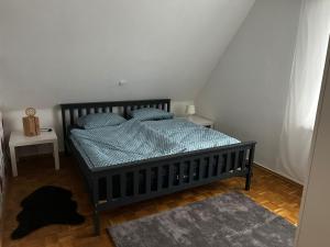 a bedroom with a bed with a blue comforter at Ferienwohnung Kierspe in Kierspe