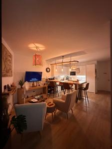 a dining room and living room with a table and chairs at Papá Totë Deluxe in Playa Honda
