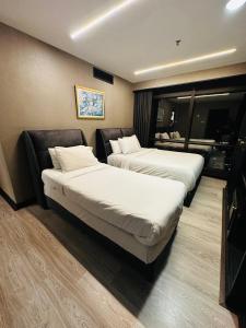 A bed or beds in a room at TaheeenS Suites at Berjaya Times Square