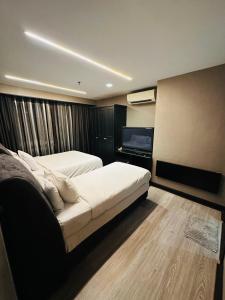 A bed or beds in a room at TaheeenS Suites at Berjaya Times Square
