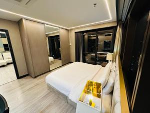 A bed or beds in a room at TaheeenS Suites at Berjaya Times Square