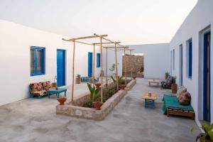 a patio with couches and plants in a building at IBI Surf House in Sidi Kaouki