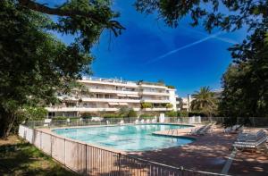 a swimming pool in front of a building at Un nid à Saint Tropez in Saint-Tropez