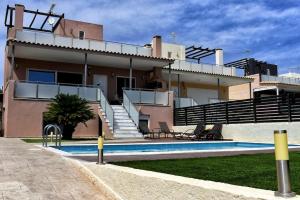 a house with a swimming pool in front of it at Villa Cat El in Isthmia