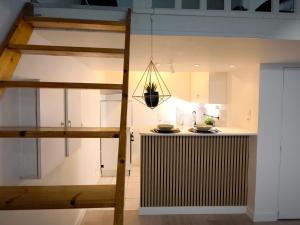 a kitchen with white cabinets and a kitchen island at Magnifique T2 Centre Ville in Le Havre
