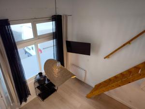 a living room with a staircase and a window at Magnifique T2 Centre Ville in Le Havre