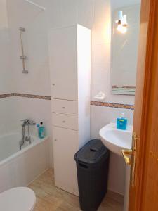 a white bathroom with a sink and a toilet at Casa Rosalia in Orihuela Costa