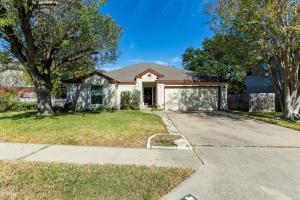 a house with a driveway in front of it at Cozy 3BR Retreat with Outdoor Dining & BBQ Grill in Pflugerville