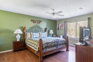a bedroom with a bed and a tv at Cozy 3BR Retreat with Outdoor Dining & BBQ Grill in Pflugerville