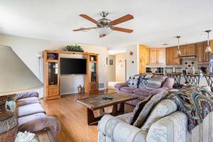 a living room with couches and a flat screen tv at Cozy 3BR Retreat with Outdoor Dining & BBQ Grill in Pflugerville