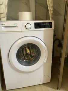 a white washer and dryer in a room at Grand appartement fabuleux in Agadir
