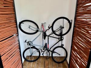 two bikes are hanging on a wall at Chic 2BR Condo, Private Jacuzzi and 2 Free Bikes in Tulum