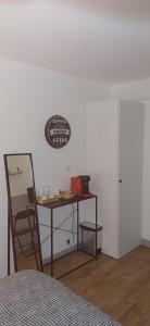 a bedroom with a desk and a table with a chair at relais st laurent in Chevreuse