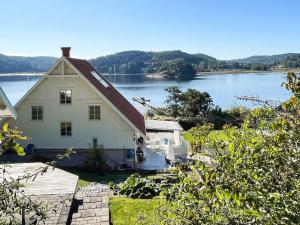 a white house with a view of a lake at 5 star holiday home in Uddevalla in Sundsandvik
