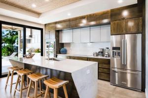 a kitchen with a large island with bar stools at Beachfront Pool 5 BD Villa in Potrero