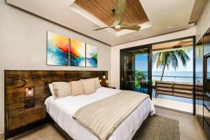 a bedroom with a bed and a view of the ocean at Beachfront Pool 5 BD Villa in Potrero