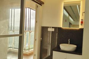 a bathroom with a sink and a mirror at 2 Bedroom River view apartment in Aluva, near Cochin Airport in Alwaye