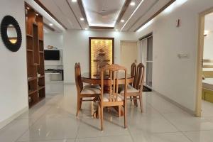 a dining room with a table and chairs at 2 Bedroom River view apartment in Aluva, near Cochin Airport in Alwaye
