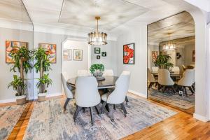 a dining room with a table and chairs at 2 Mi to Downtown Flushing Spacious Retreat! in Flint +17 photos