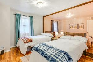 a bedroom with two beds and a window at 2 Mi to Downtown Flushing Spacious Retreat! in Flint