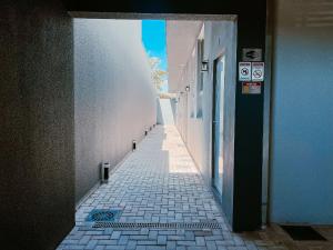 a narrow alley with a blue sky in the distance at Mini Loft Siena in Sinop