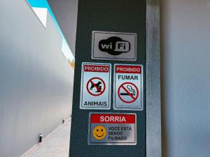 a group of signs on a green wall at Mini Loft Siena in Sinop