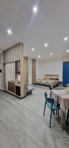 a large room with two beds and a table and chairs at Etruria Apartments Salerno in Salerno