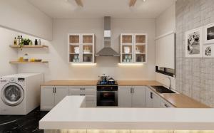 a kitchen with white cabinets and a washer and dryer at The Acropolis Penthouse in Athens