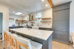 a kitchen with a large kitchen island with white counter tops at Walk to Roanoke River Greenway Mountain-View Home in Roanoke
