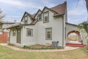 a white house with an archway in a yard at Walk to Roanoke River Greenway Mountain-View Home in Roanoke