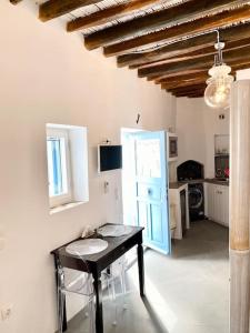 a kitchen with a table and a counter in a room at Cyclops House in Serifos Chora