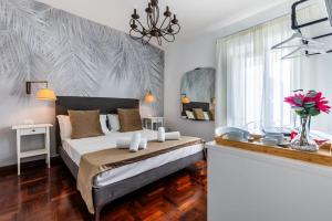 a bedroom with a bed and a vase of flowers at Fantastic Rome Guest House in Rome +52 photos