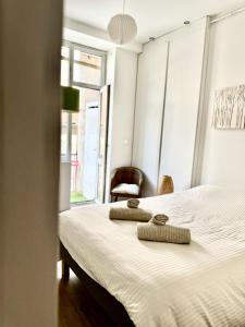 Ένα ή περισσότερα κρεβάτια σε δωμάτιο στο Le Cocon de la Presqu'île