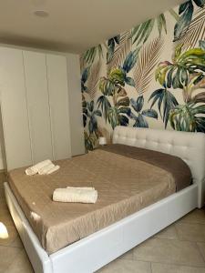 a bedroom with a bed with towels on it at Sole e Mare in Catania