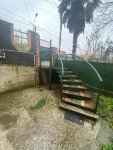 a set of stairs with a green hand rail at Gogol House in Kutaisi +6 photos