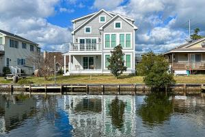 a large house on the side of a body of water at South Bethany --- 102 Brandywine Dr in Bethany Beach